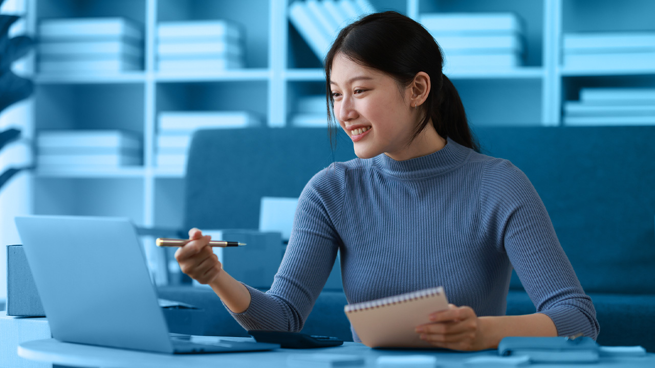 Woman pointing at computer monitor